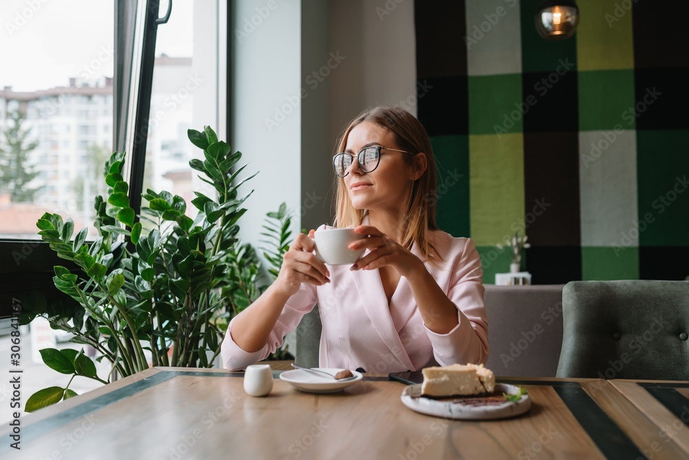 Smiling businesswoman using tablet computer coffee shop