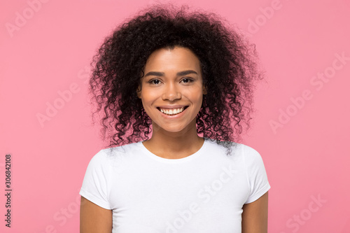 Head shot portrait smiling African American woman looking at camera © fizkes