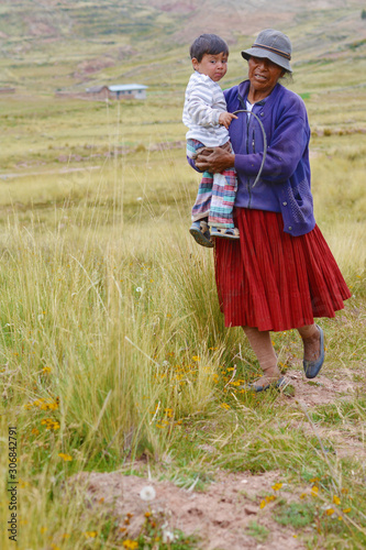 Native american woman with little boy in the countryside.