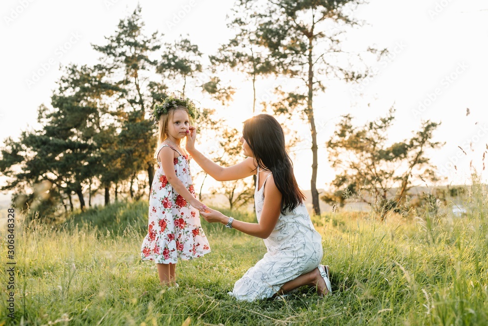 Stylish mother and handsome daughter having fun on the nature. Happy family concept. Beauty nature scene with family outdoor lifestyle. family resting together. Happiness in family life. Mothers day Stylish mother and handsome daughter having fun on the nature. Happy family concept. Beauty nature scene with family outdoor lifestyle. family resting together. Happiness in family life. Mothers day