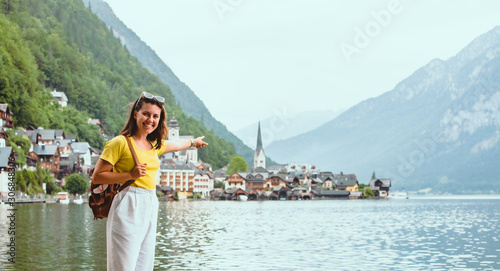 woman standing on the beach looking at hallstatt city