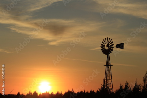 windmill at sunset with a colorful Sky and clouds.