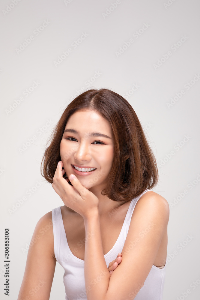 Beautiful Asian young woman touching soft cheek smile with clean and fresh skin Happiness and cheerful with positive emotional,isolated on gray background,Beauty and Cosmetics Concept Beautiful Asian young woman touching soft cheek smile with clean and fresh skin Happiness and cheerful with positive emotional,isolated on gray background,Beauty and Cosmetics Concept