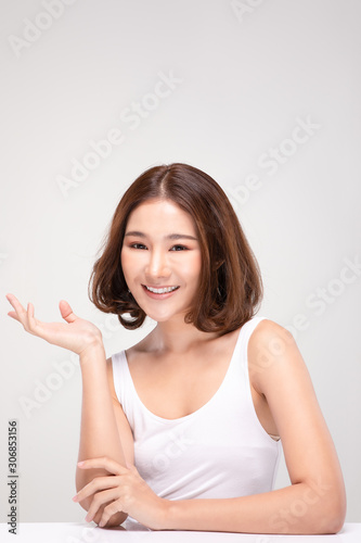 Beautiful Attractive Charming Asian young woman smile with white teeth open hand palm for display cosmetics product cheerful with healthy skin,isolated on white background,Beauty Cosmetics Concept