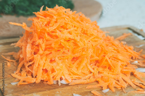 grated carrots on a cutting Board