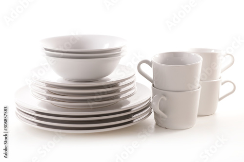 pile of plates empty with mug and bowl isolated on white background