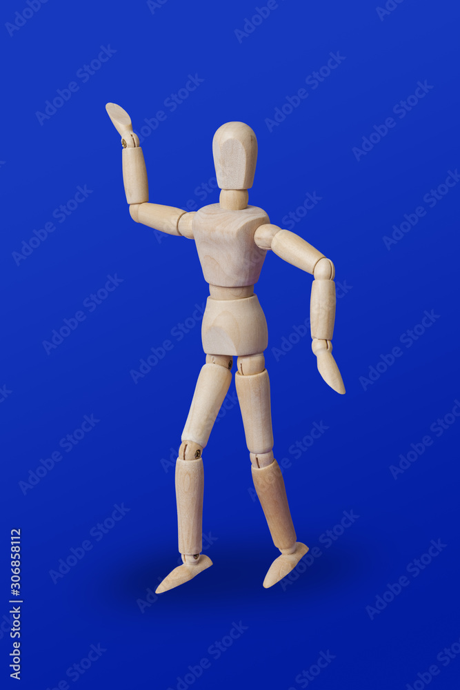 Dancing wooden toy figure on blue Dancing wooden toy figure on blue