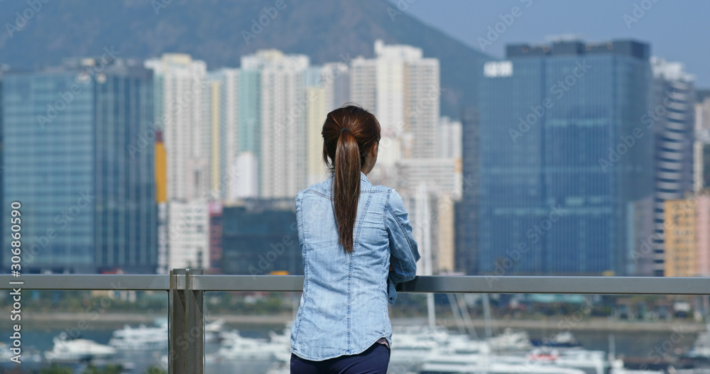 Woman look at the city view in Hong Kong
