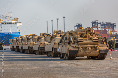 Military vehicle  Convoy of armored vehicle at terminal port  Tank tracks and steel wheels huge panzer.