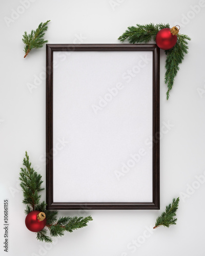 Christmas or New Year composition. Photo frame with copy space, Christmas tree branches and Christmas balls on white background. Flat lay, top view, vertical layout