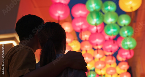 Couple look at the chinese lantern together at outdoor