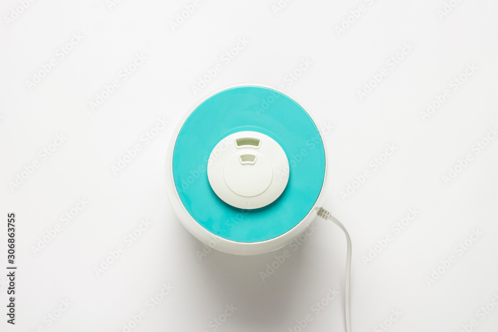 Humidifier for air on a white background. Health care concept, dust control. Flat lay, top view