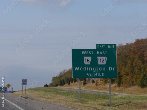 Roadside signs and directions to Wedington Drive along Interstate 49 in Arkansas. photo