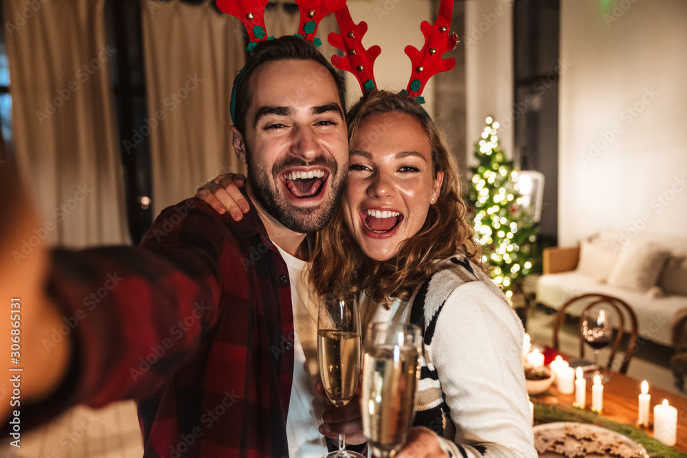 Photo of nice happy couple drinking wine and taking selfie photo