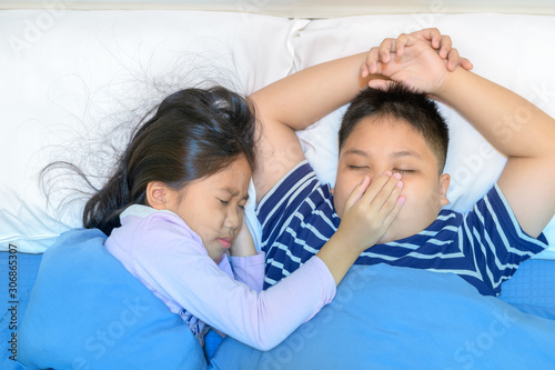 Annoying snoring. Sister covered her brother's mouth.