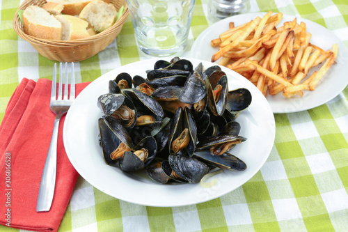 plate of mussels and fries on a table