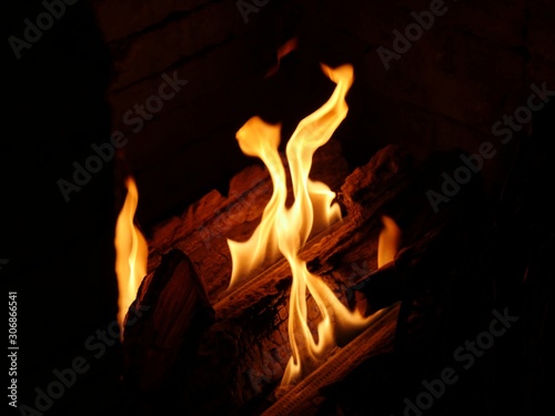 Hot flames from a log burning in a fireplace