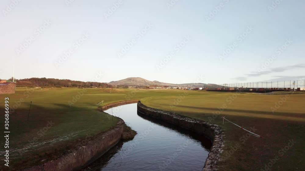 Deserted scottish links golf course with stream running through Deserted scottish links golf course with stream running through