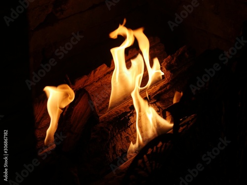 Close up of tongues of flames from a burning log in a fireplace