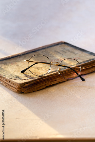 Gold round Glasses on vintage book