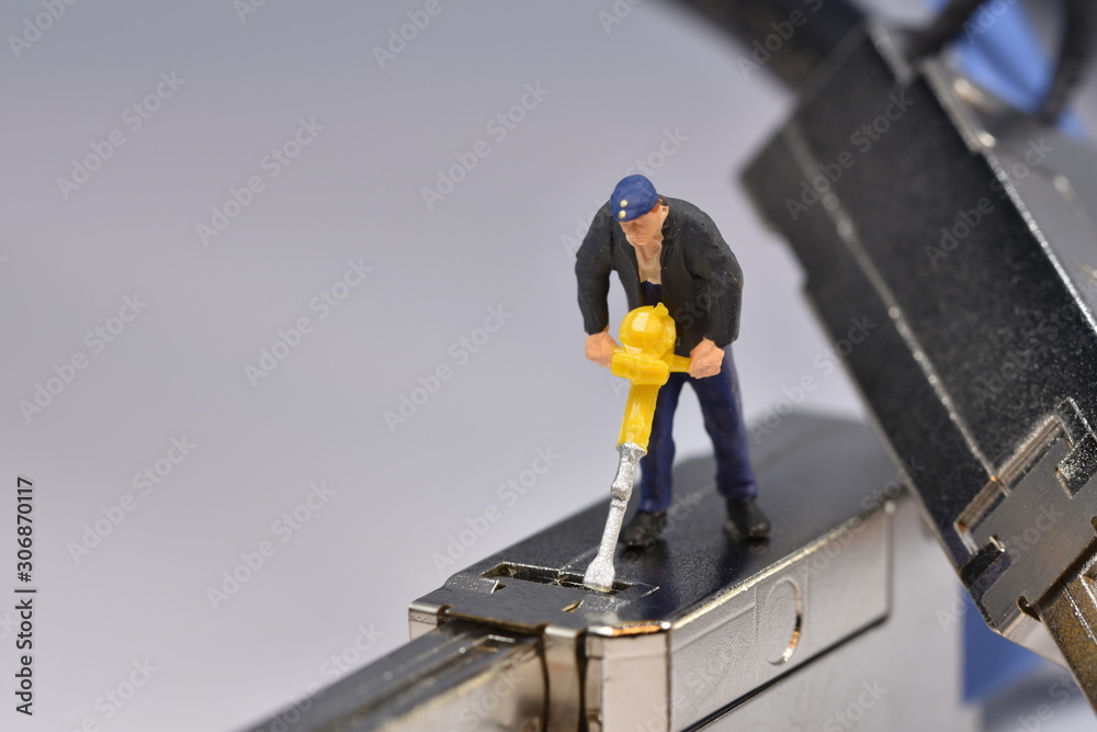 Tiny worker is working on a plug miniature repair scale Tiny worker is working on a plug miniature repair scale