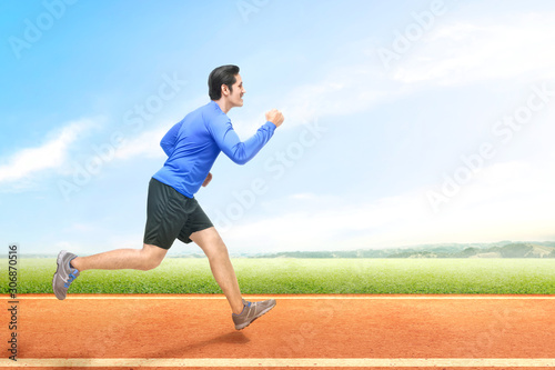 Asian runner man running on the running track © Leo Lintang