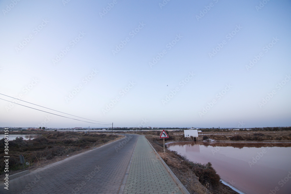 Sunset in Tavira salt ponds Algarve Portugal