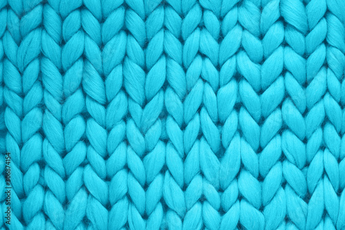 Texture of blue wool big knit blanket. Large knitting. Plaid merino wool. Top view
