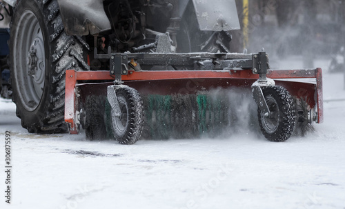 Tractor cleans the sidewalks of snow. Snow removal equipment