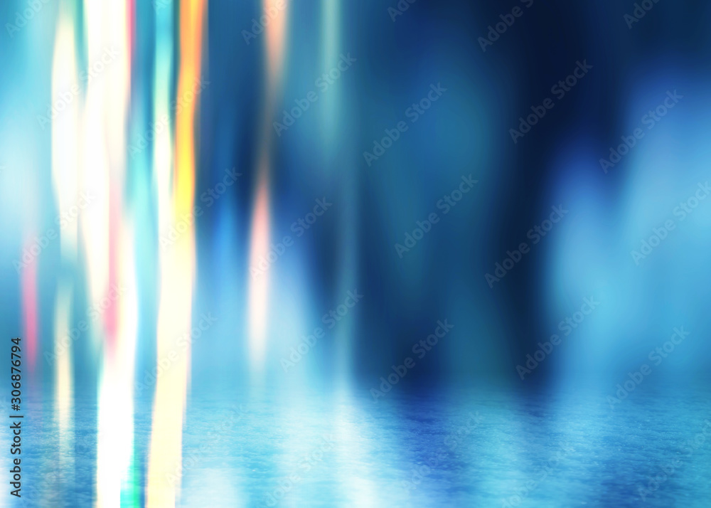 Winter abstract, blurred background with bokeh. Blurry night city lights in reflection on a snowy road. Neon light, falling snow, snowflakes.