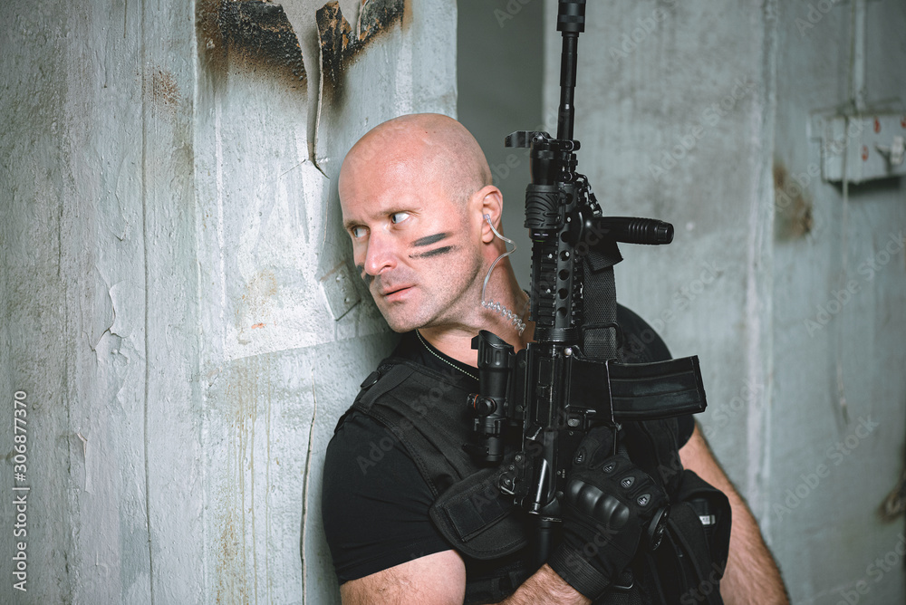 Fototapeta premium Concept photo of special agent man with a rifle. Person with airsoft gun. Thriller film concept.