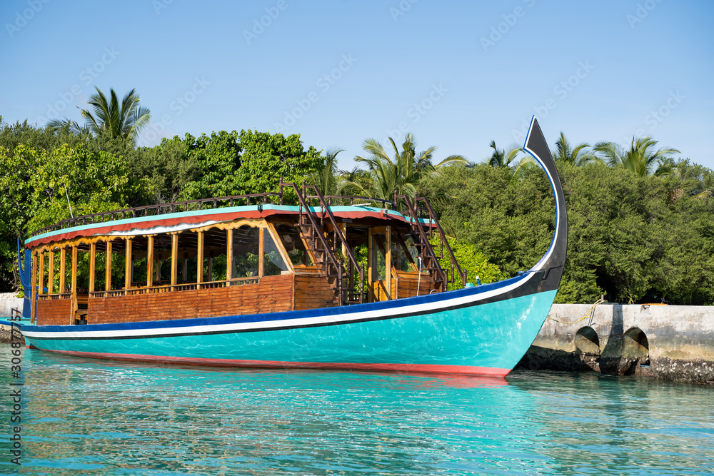 A Dhoni boat (also known as a Doni boat) is a traditional sail boat used in the Maldives. Boat is docked