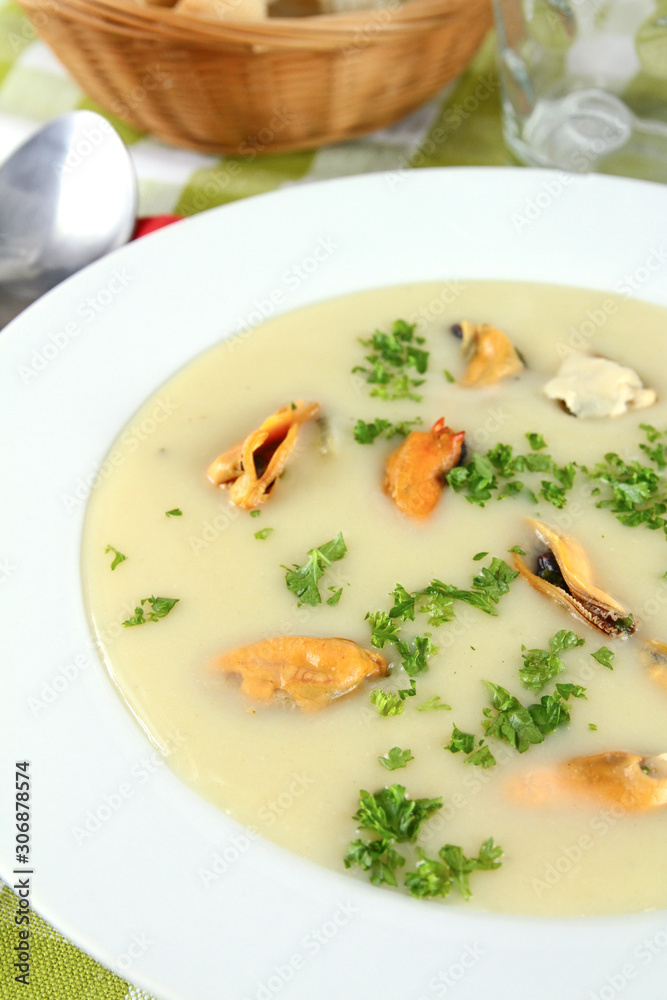 plate of mussel soup on a table