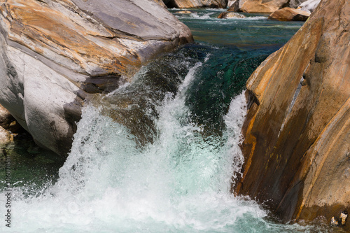 wild cascade of Verzasca river in Ticino Switzerland in shunshine