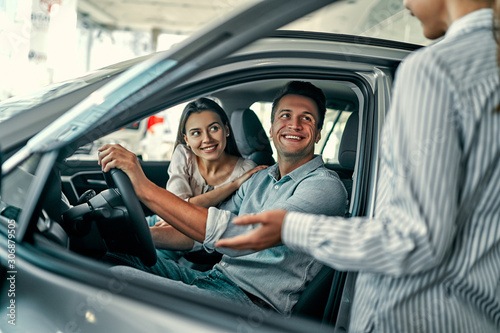 At a car dealership, buying a car © Valerii Apetroaiei