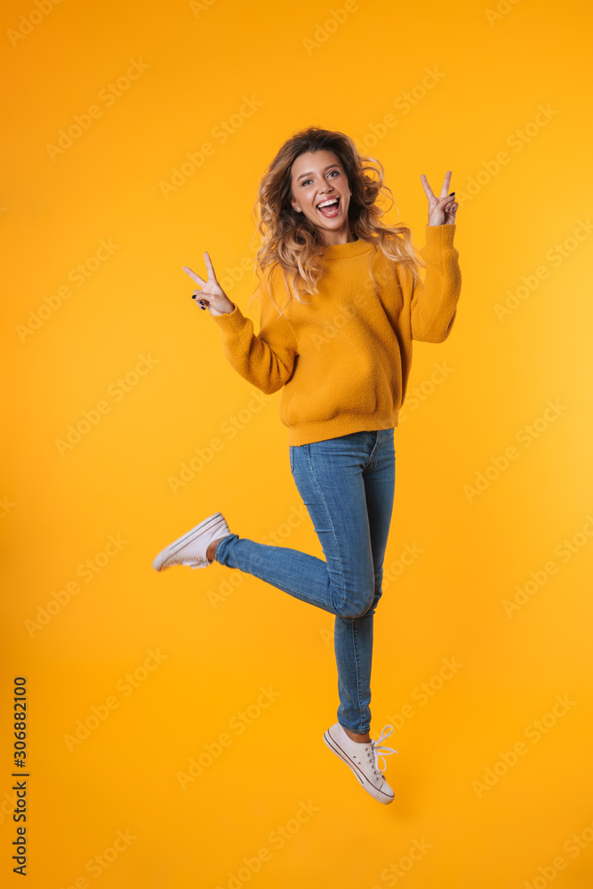 Full length image of attractive blonde woman showing peace sign Full length image of attractive blonde woman showing peace sign
