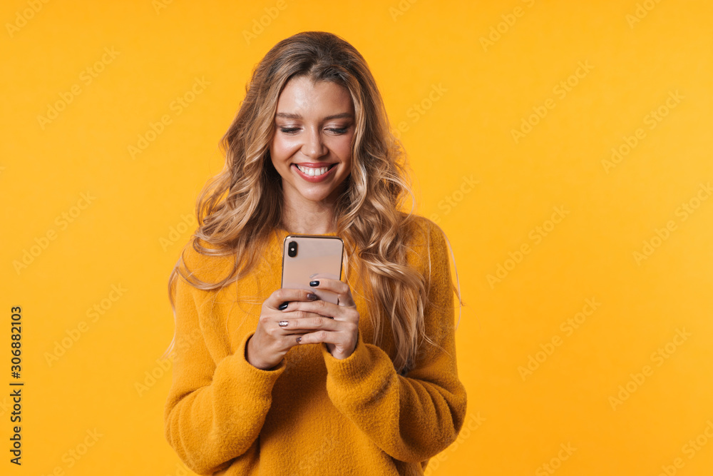 Image of attractive blonde woman smiling and holding cellphone