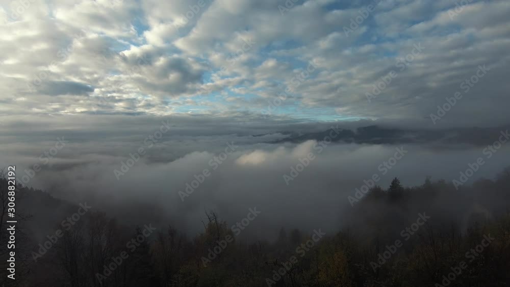 Time lapse partially covered clouds on sky and low fog in valley Time lapse partially covered clouds on sky and low fog in valley