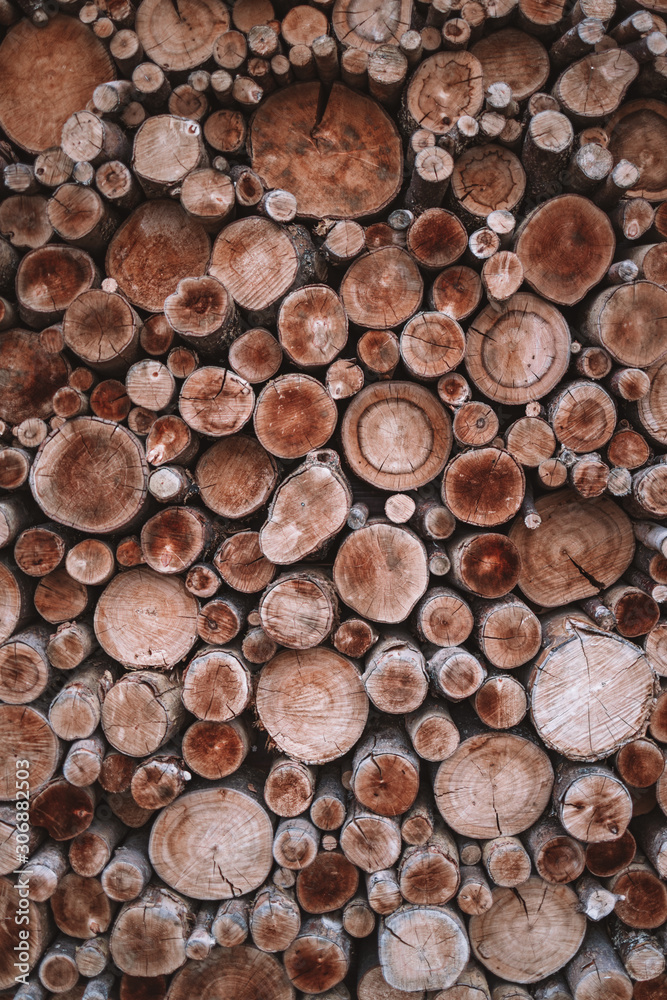 A lot of round firewood on top of each other A lot of round firewood on top of each other