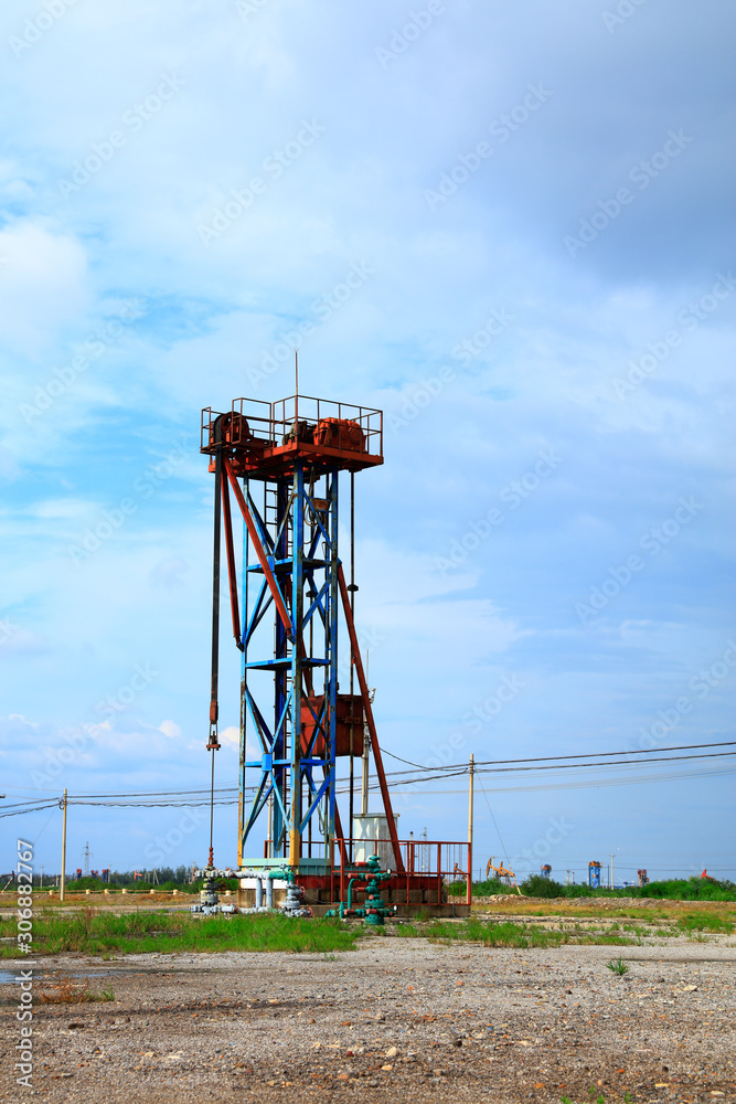 Oil fields in the evening, oil field derrick in the evening,  sunset and sunset