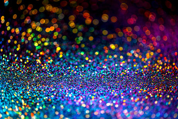Shiny multicolor glitter raster background. Abstract shimmering pink, blue, yellow circles decorative backdrop. Bokeh lights effect illustration. Overlapping glowing and twinkling spots.