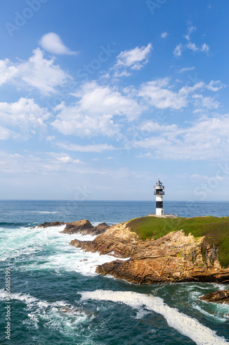 Lonely lighthouse on the coast of Galicia, Spain. Island of Pancha near Ribadeo