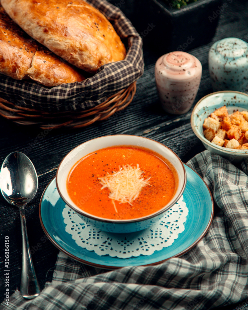 tomato soup with grated cheese and crackers