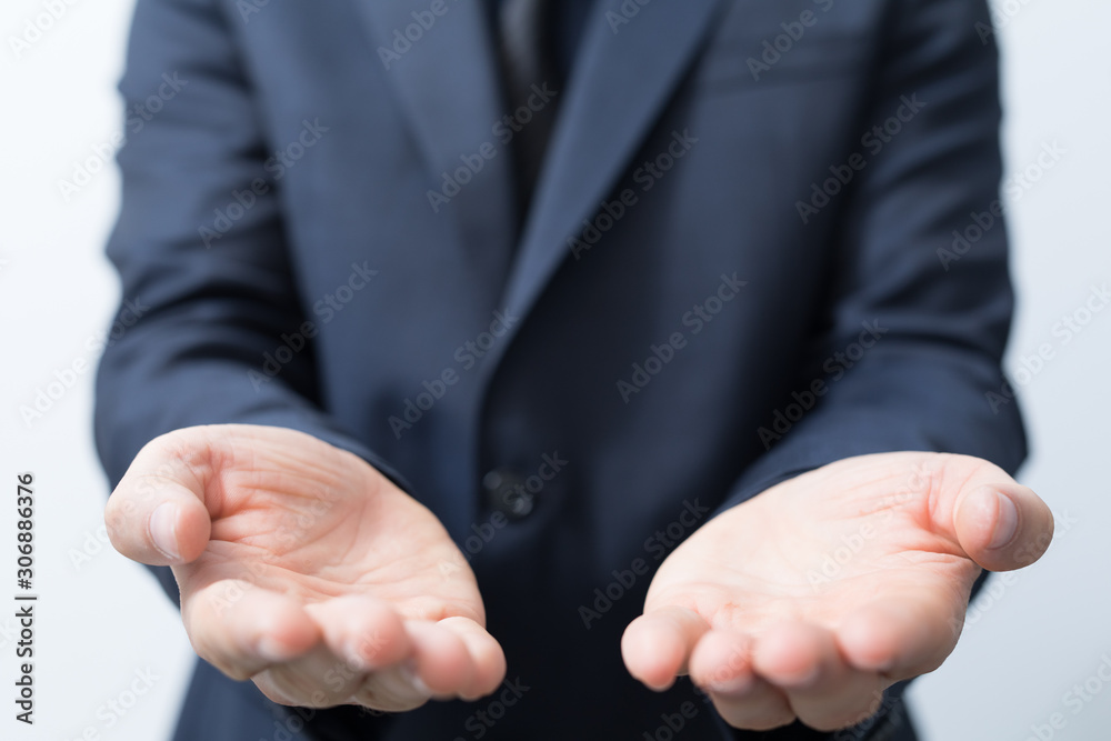 Fototapeta premium Businessman without head holding something without theme.