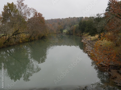 Wide shot of the War Eagle River with colorful trees along the banks in autumn