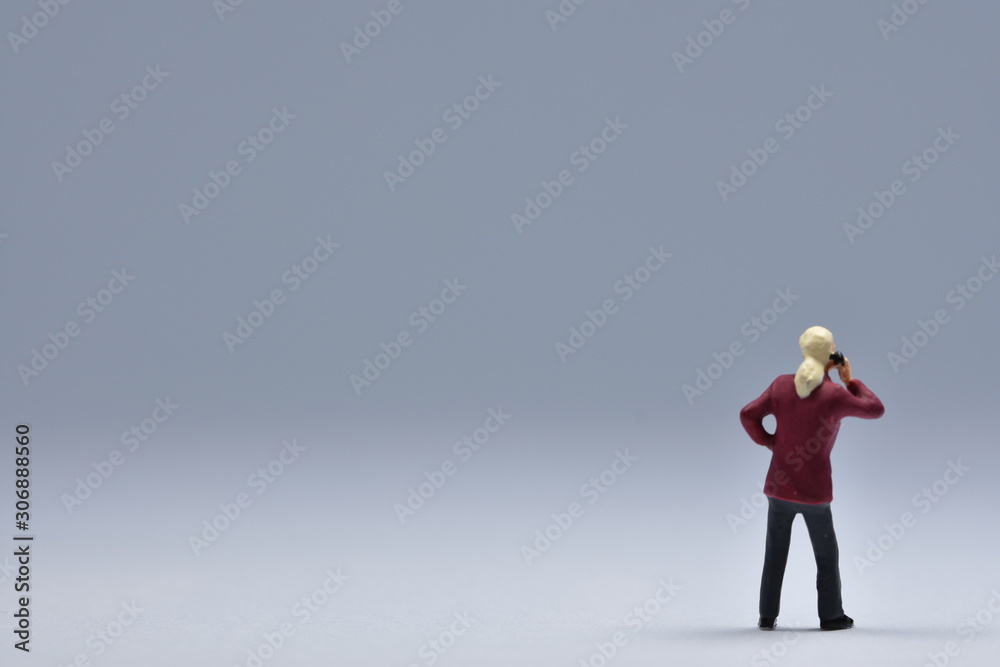 miniatuer figure man is talking on a cellular phone miniatuer figure man is talking on a cellular phone