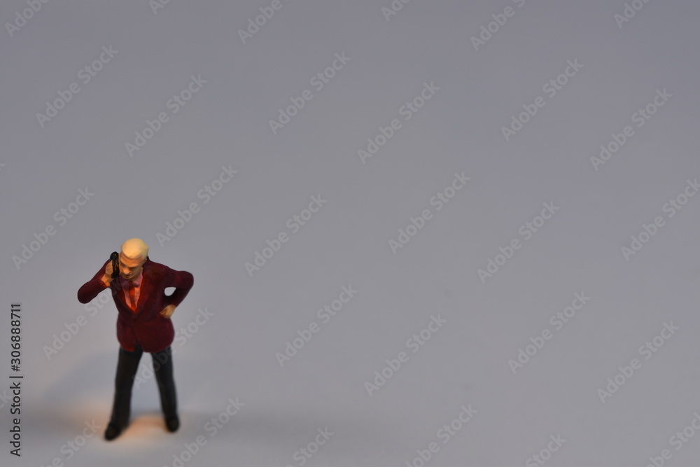 tiny people are talking on a cellular mobiel phone tiny people are talking on a cellular mobiel phone