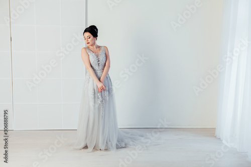 bride in wedding dress in white room photo