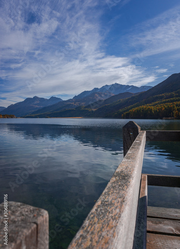 The Sils lake, the forest, the nature and the alps near the village of Maloja, Engadin, Switzerland - October 2019.