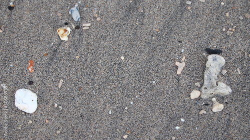 the rocks on the beach sand are gray in the morning, with less light, out of focus, suitable for the background